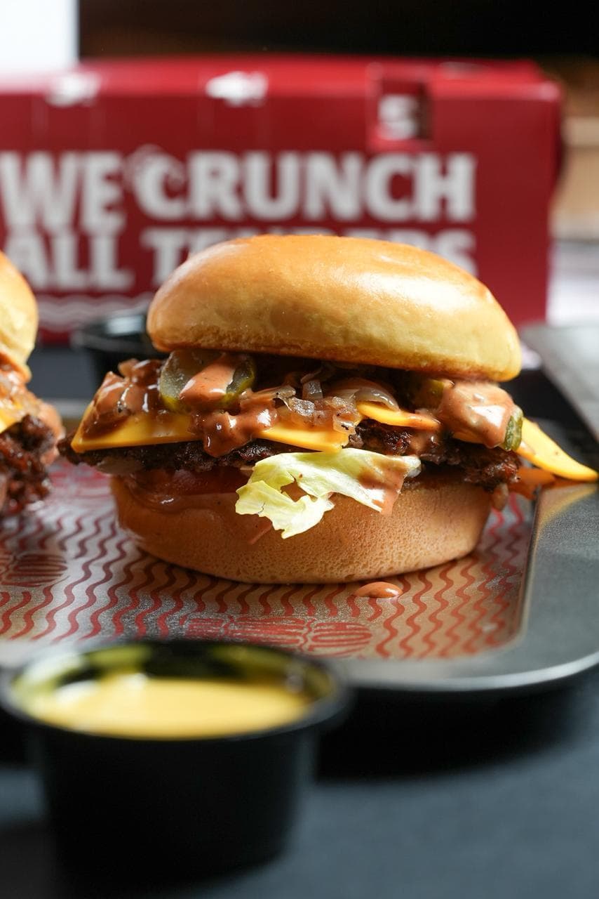 Smashed cheeseburger with pickles, onion and smash sauce on a Holy Smash Burger tray