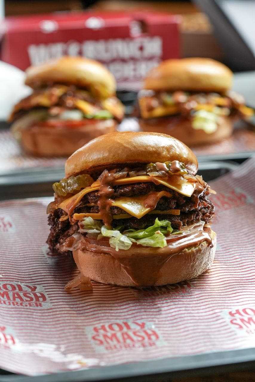 Triple-stacked smash burger with three beef patties and melted cheese